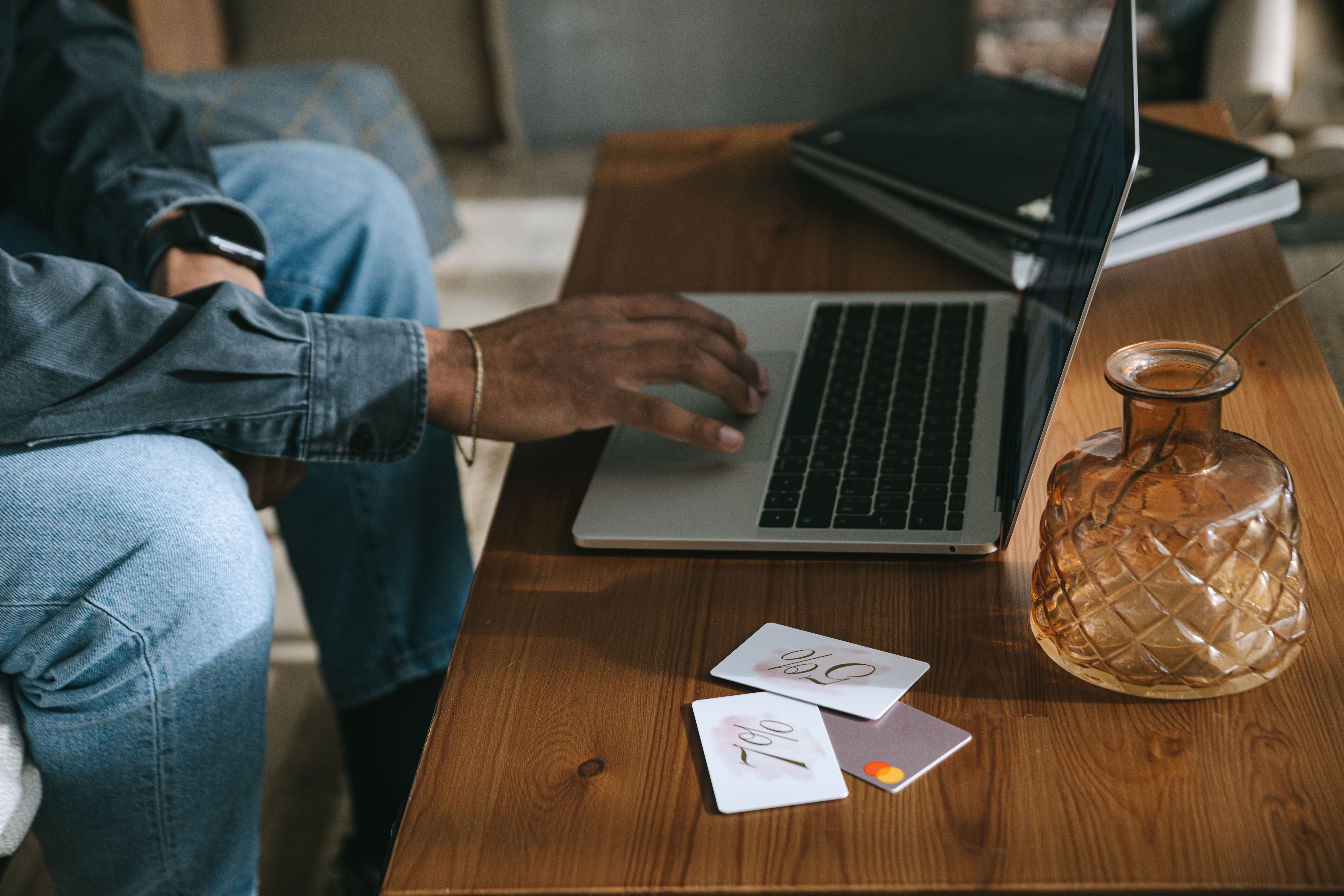 Solopreneur reviewing business credit card options on a laptop at a home office desk